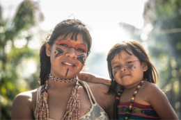 Brazilian indigenous woman holds child