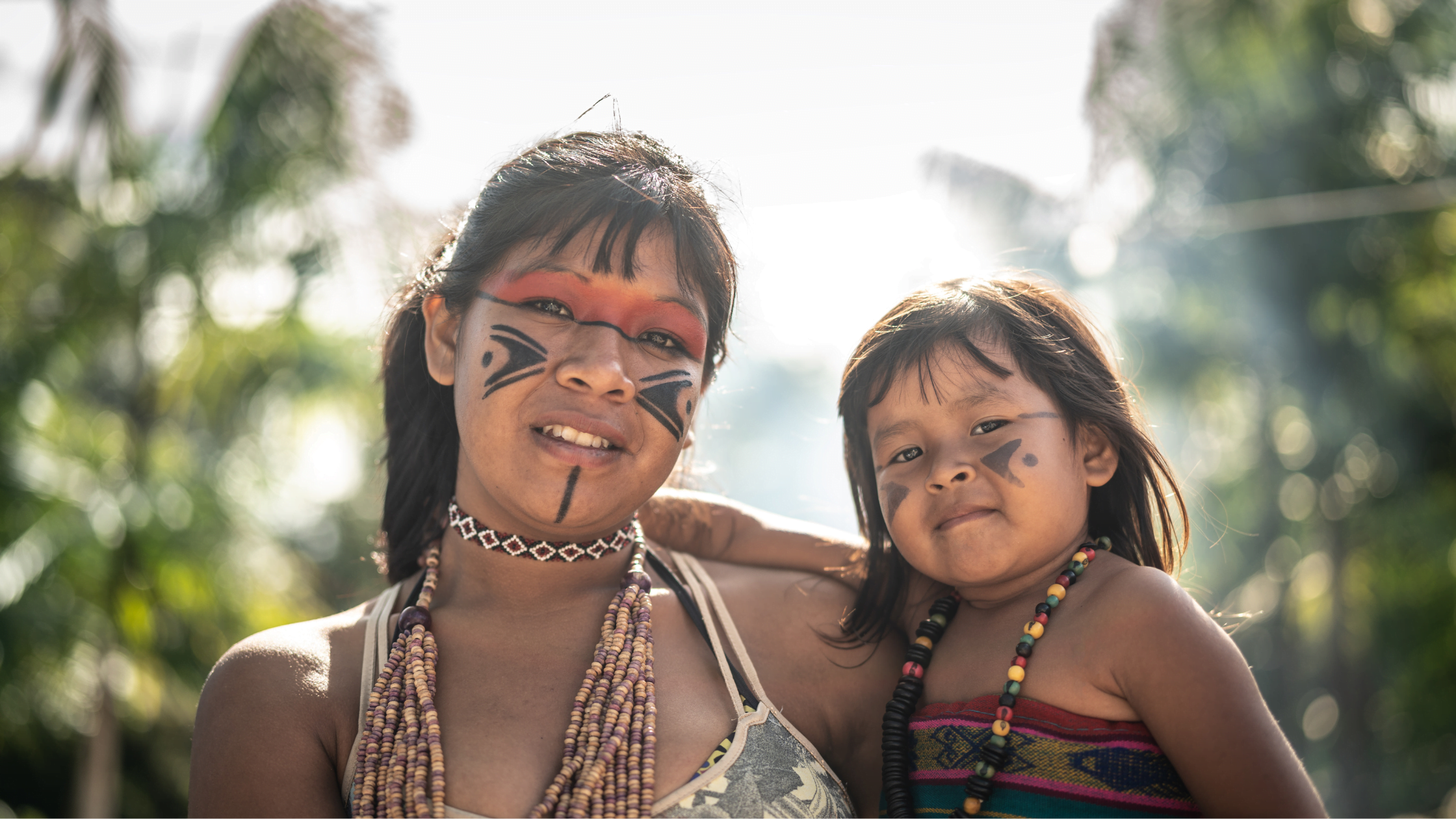 Brazilian indigenous woman holds child