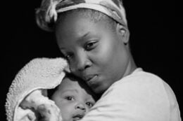 black mothers holds baby, doulas, world doula week